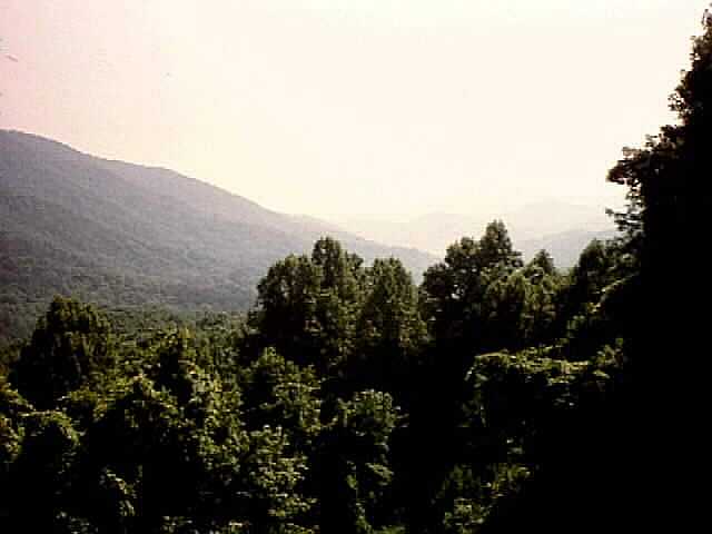 a picture of a beautiful mountain scene with background haze